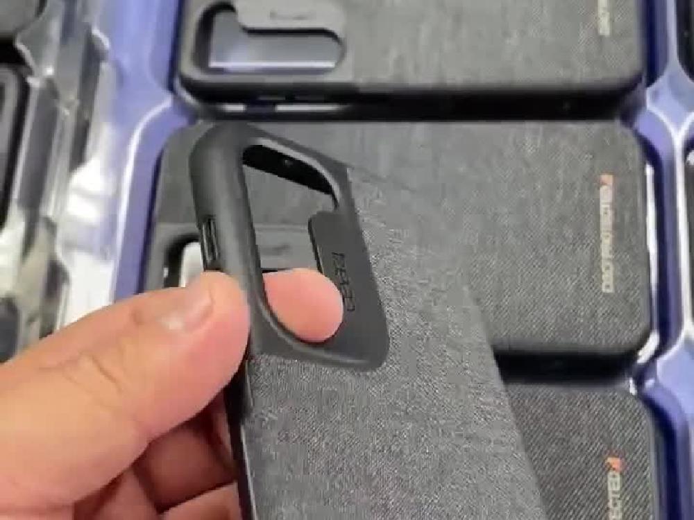 Black phone-case camera surround held above leather-finished cases